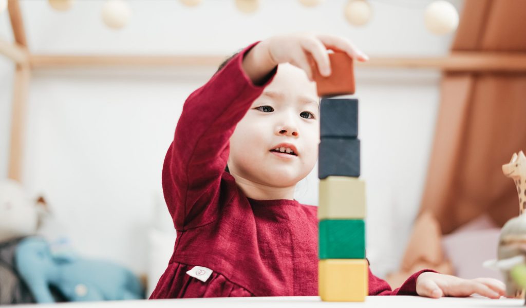 A little boy stacking blocks